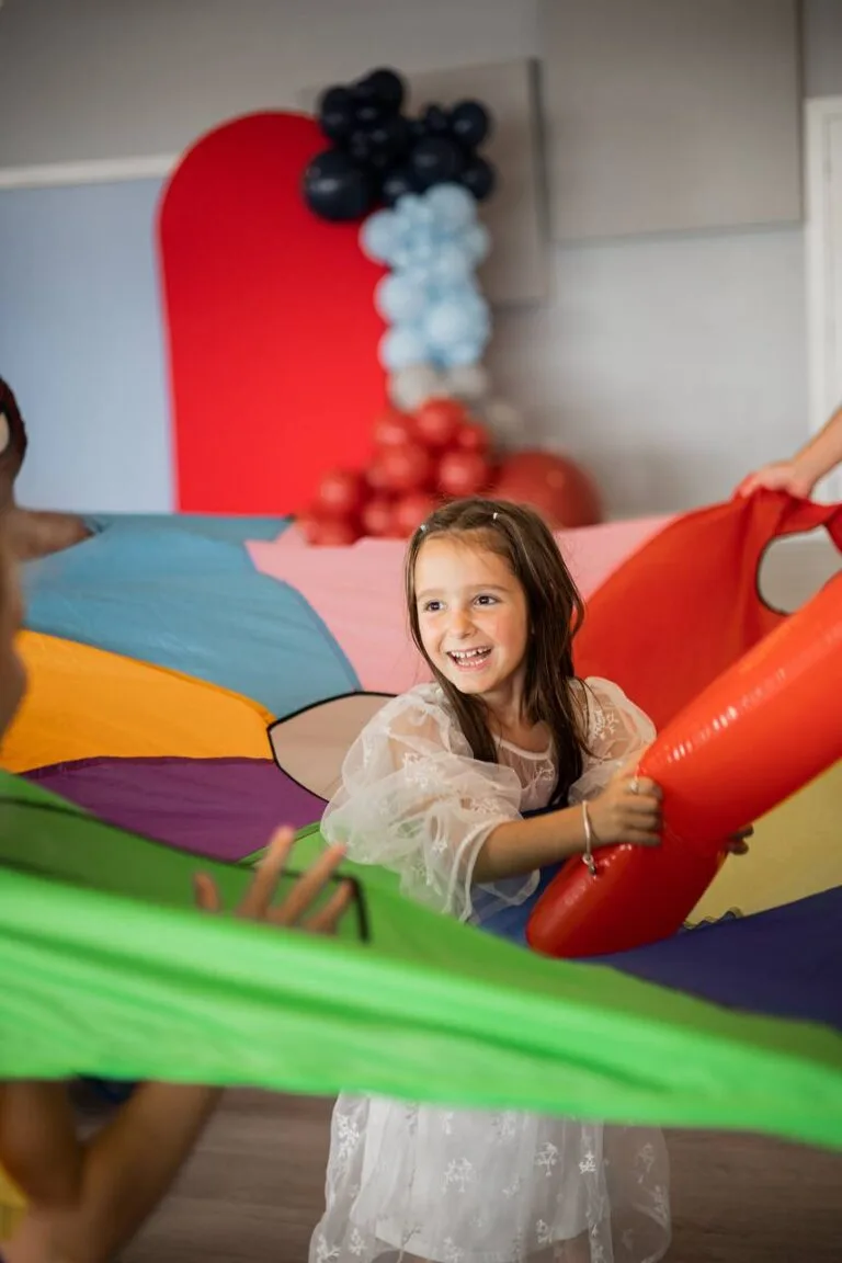 Child playing on an inflatable attraction at a birthday party